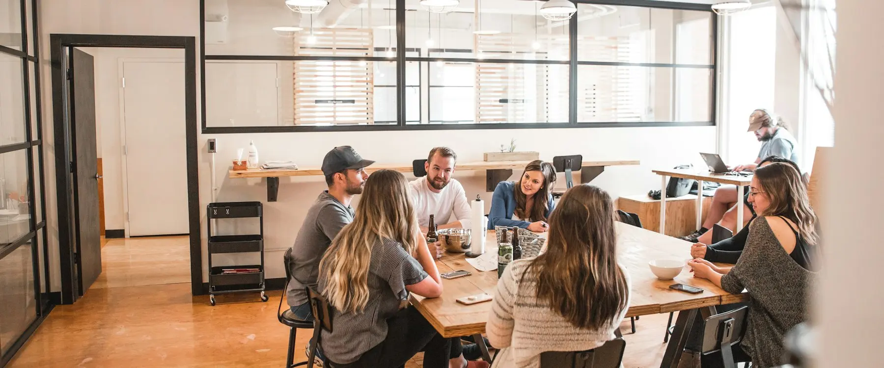 Une équipe échange autour d’une table dans un espace de travail